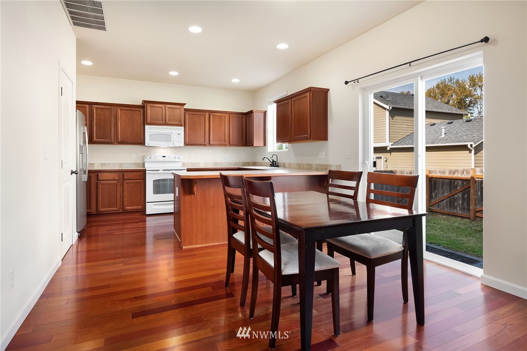 4532 Northeast 10th Street Renton, WA 98059 - Photo 8 of 24 a dining table with chairs and wooden floor
