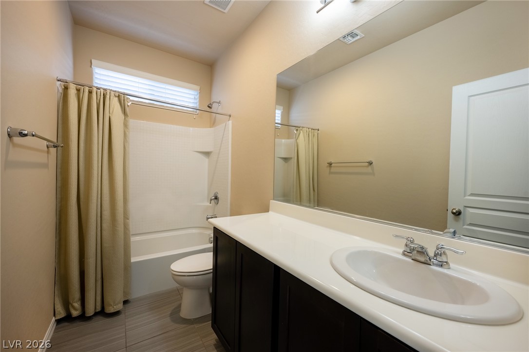 11016 Prairie Grove Road Las Vegas, NV 89179 - Photo 22 of 37 A well-appointed bath features a sleek vanity and convenient tub-shower combination.