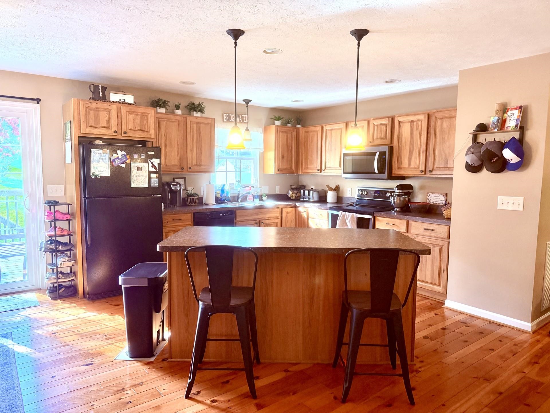 10909 Cook Town Road Bridgewater, VA 22812 - Photo 8 of 23 a dining table chairs and a stove sitting inside of a kitchen