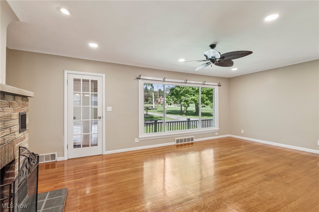 5097 Chillicothe Road Chagrin Falls, OH 44022 - Photo 5 of 45 Unfurnished living room featuring a fireplace, a ceiling fan, wood finished floors, and recessed lighting