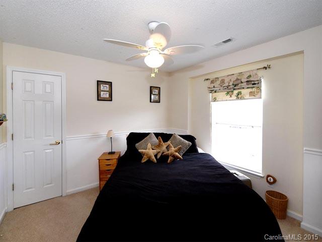 919 Knightsbridge Road Fort Mill, SC 29708 - Photo 14 of 24 a bedroom with a bed and a chandelier