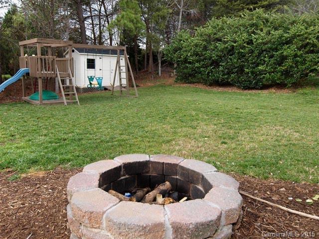 919 Knightsbridge Road Fort Mill, SC 29708 - Photo 16 of 24 a view of a backyard with table and chairs and a barbeque with wooden fence