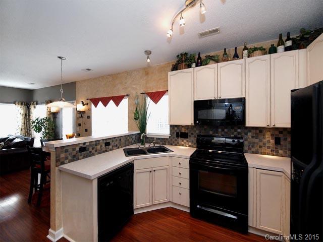 919 Knightsbridge Road Fort Mill, SC 29708 - Photo 7 of 24 a kitchen with stainless steel appliances a stove a sink and a refrigerator