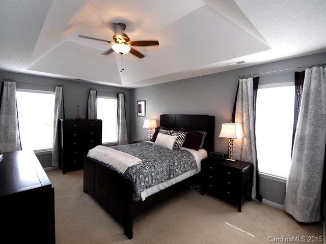 919 Knightsbridge Road Fort Mill, SC 29708 - Photo 9 of 24 a bedroom with a bed and a chandelier
