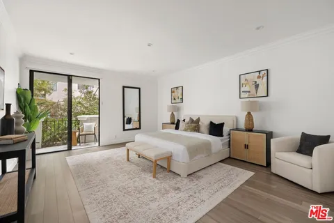 a spacious bedroom with a large bed and a couch