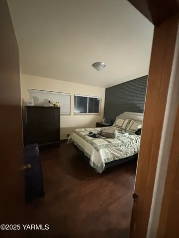 a bedroom with furniture and a window