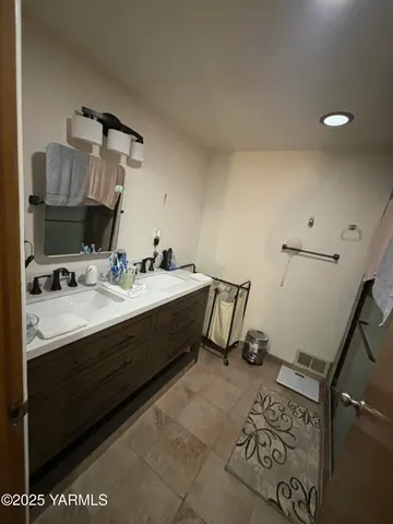 a bathroom with a double vanity sink and a mirror