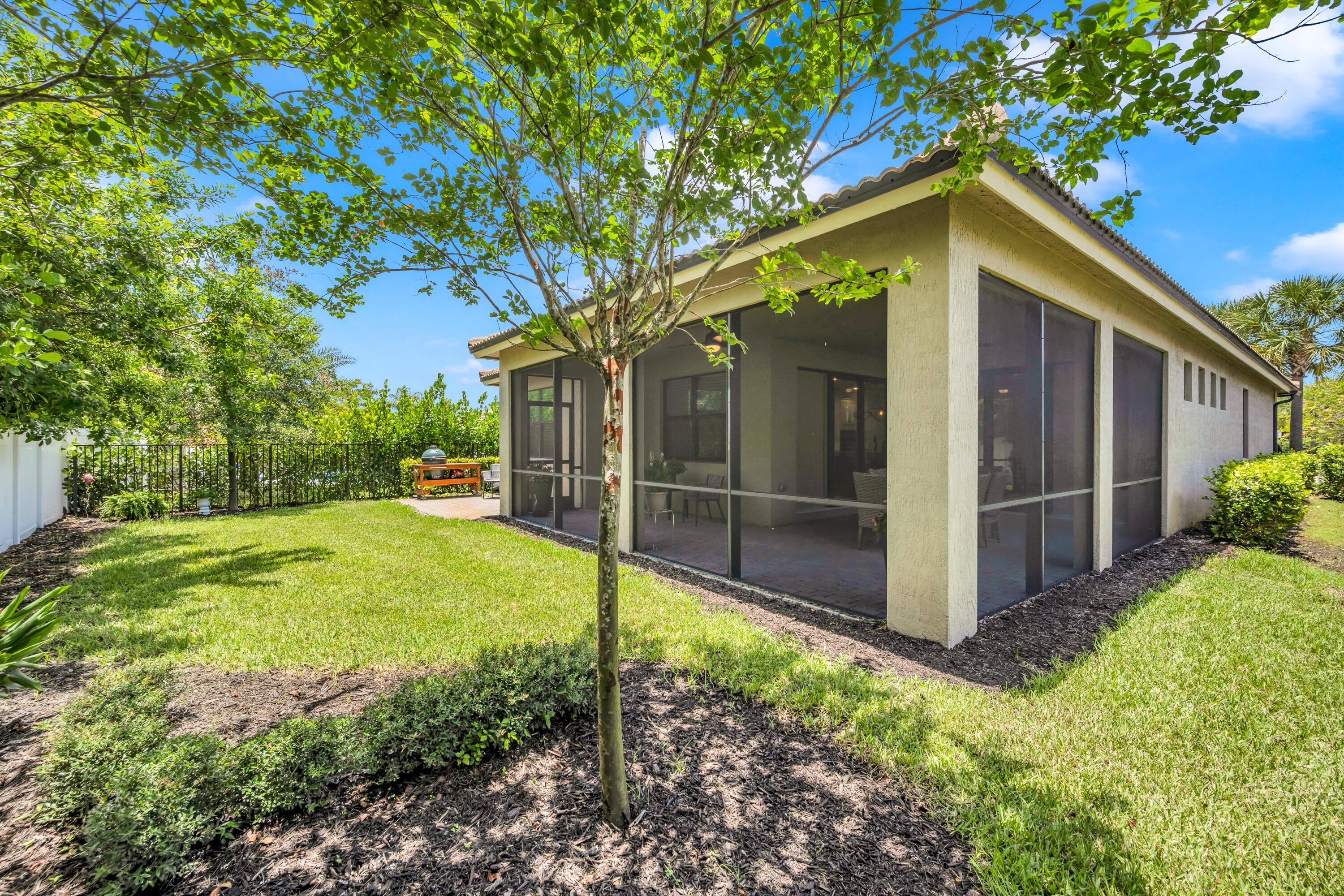 8028 Northwest 78th Street Tamarac, FL 33321 - Photo 29 of 38 a view of a backyard with large trees and a small yard