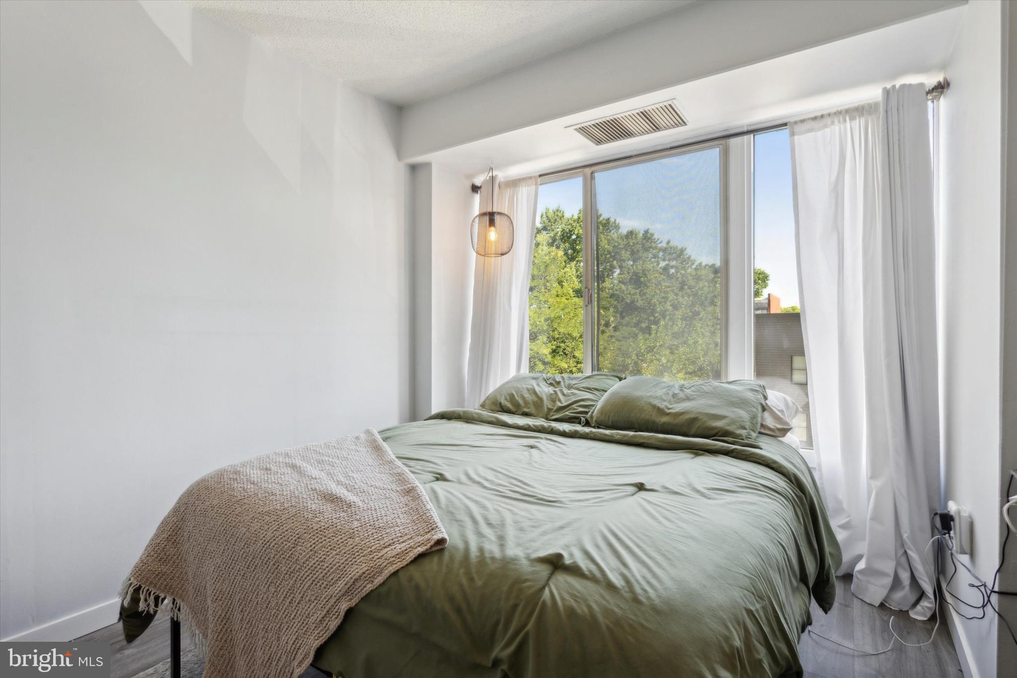 2001 Hamilton Street, Unit 521 Philadelphia, PA 19130 - Photo 16 of 27 a bedroom with a bed and a window