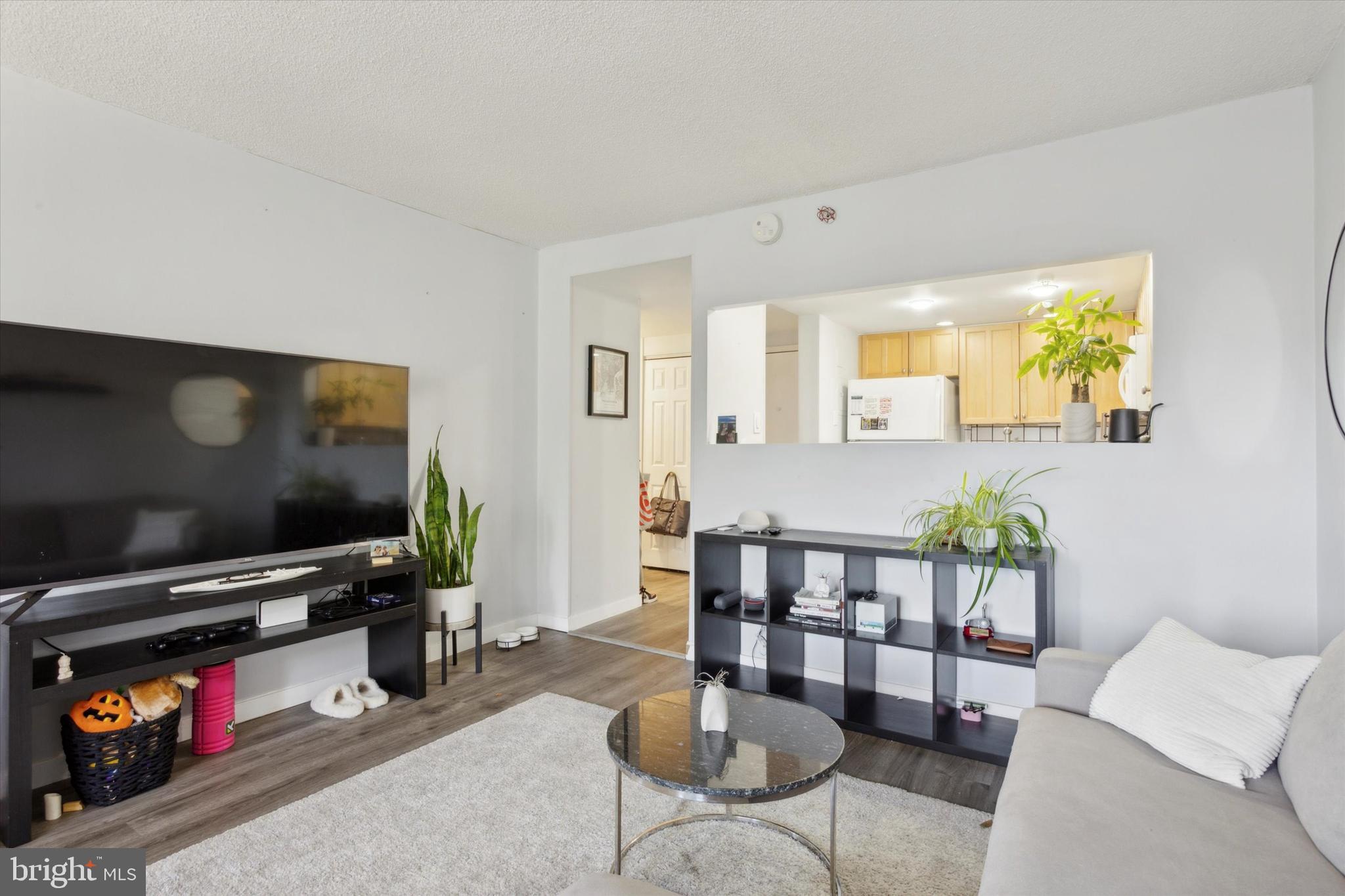 2001 Hamilton Street, Unit 521 Philadelphia, PA 19130 - Photo 3 of 27 a living room with furniture and a flat screen tv