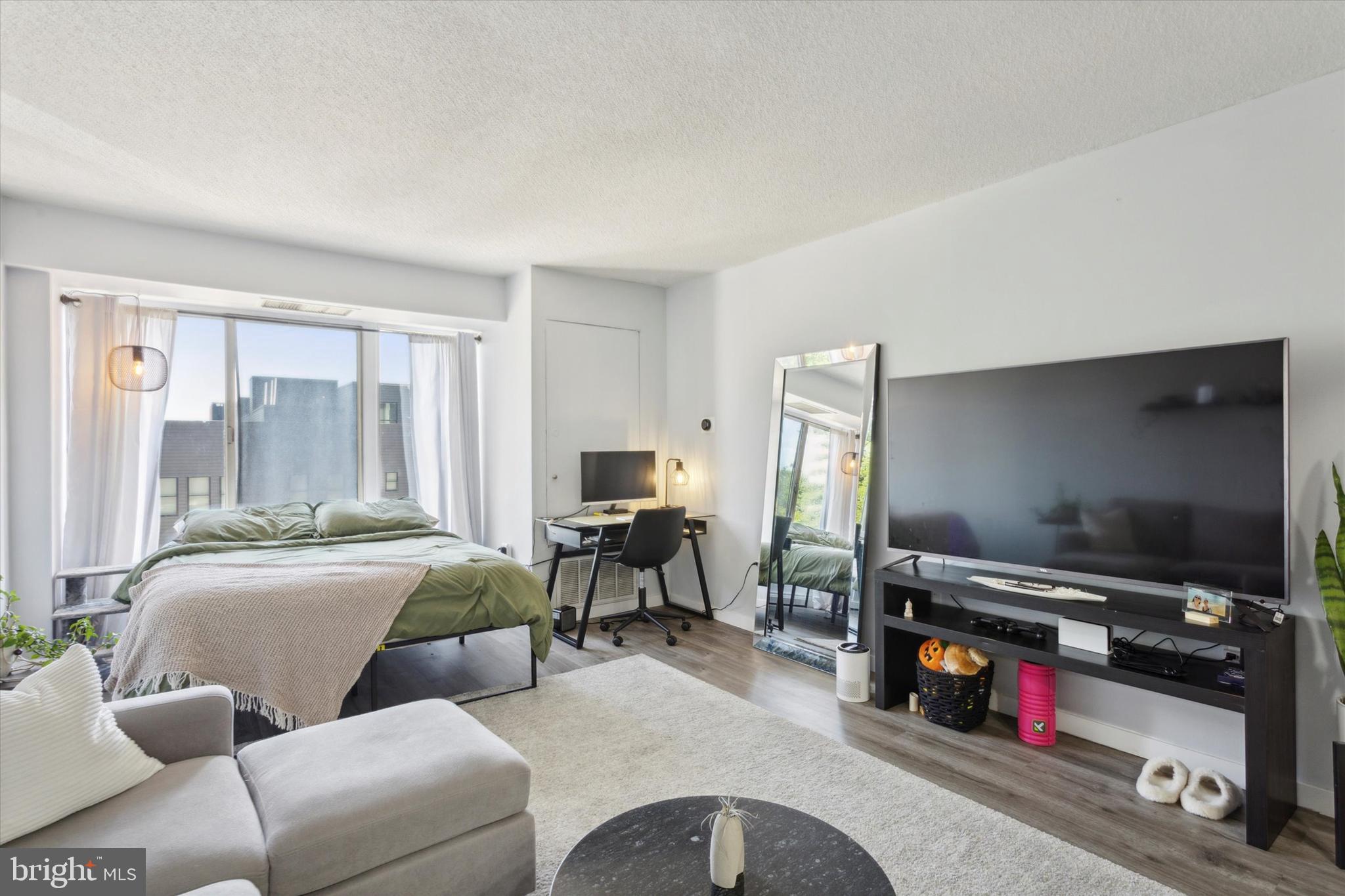 2001 Hamilton Street, Unit 521 Philadelphia, PA 19130 - Photo 6 of 27 a living room with furniture and a flat screen tv