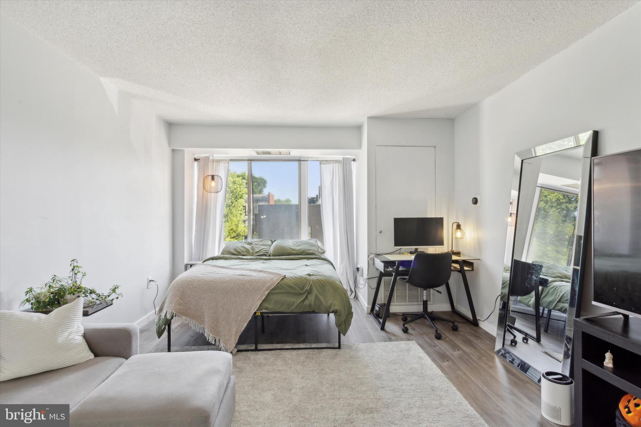 2001 Hamilton Street, Unit 521 Philadelphia, PA 19130 - Photo 7 of 27 a bedroom with a bed and a flat screen tv