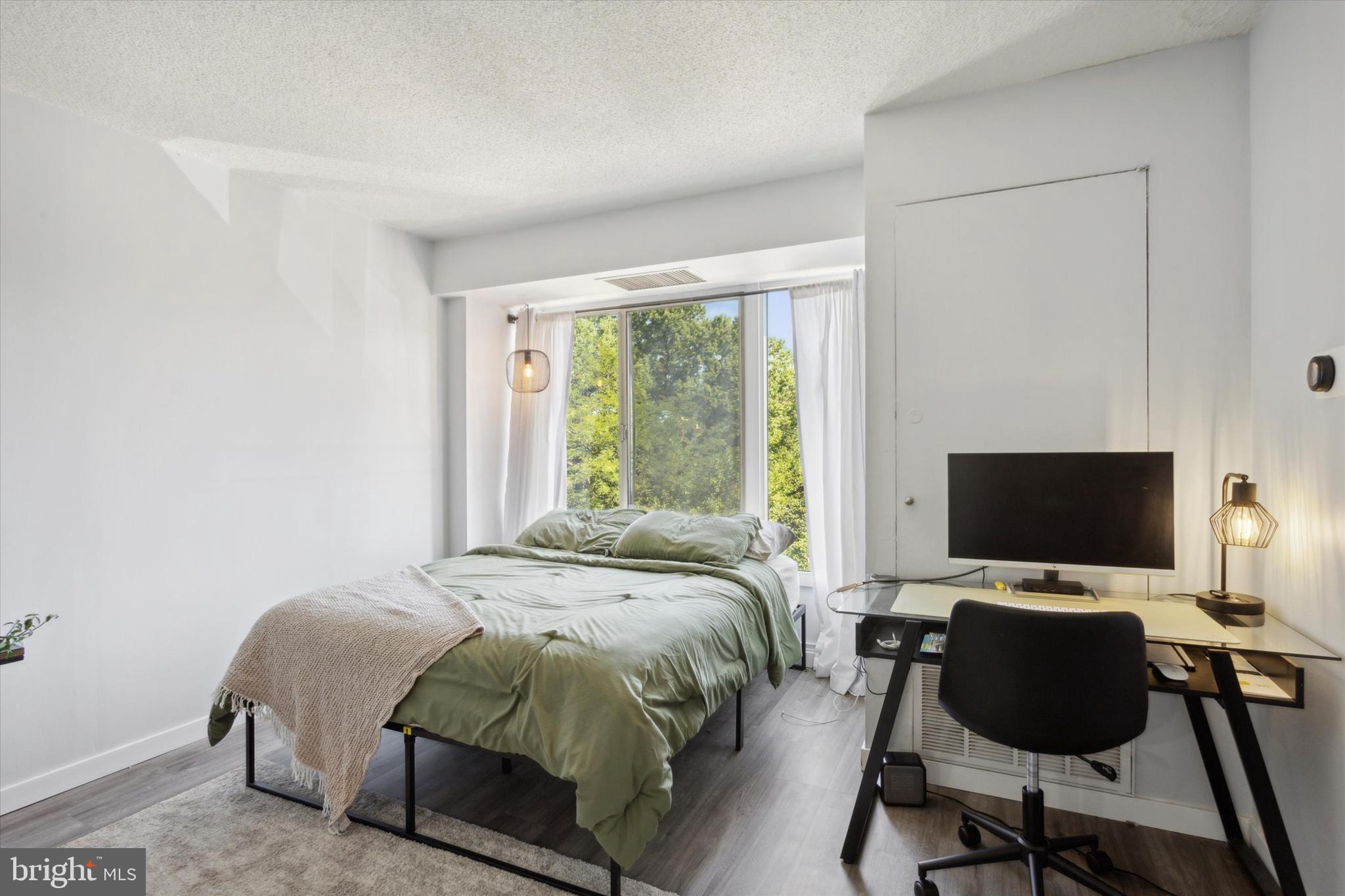 2001 Hamilton Street, Unit 521 Philadelphia, PA 19130 - Photo 8 of 27 a bedroom with a bed and a flat screen tv