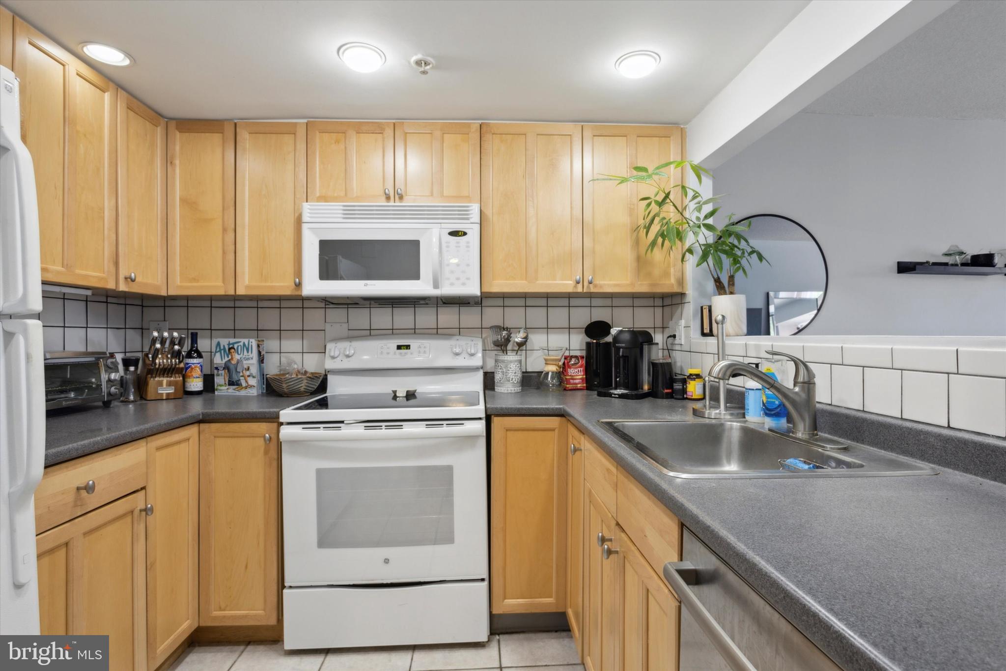 2001 Hamilton Street, Unit 521 Philadelphia, PA 19130 - Photo 10 of 27 a kitchen with a sink stove top oven and cabinets