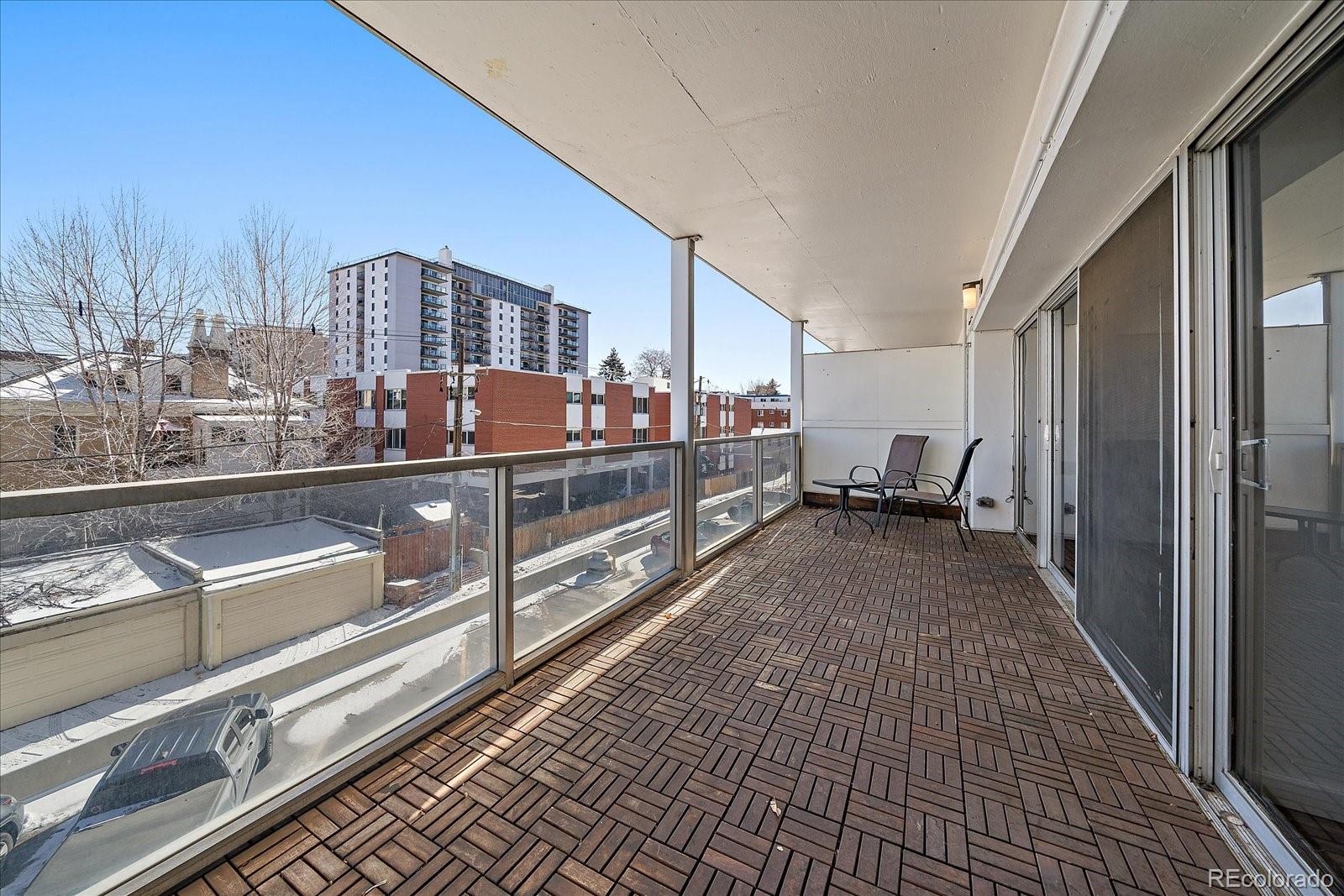 888 Logan Street, Unit 4F Denver, CO 80203 - Photo 13 of 21 a view of a balcony with chairs