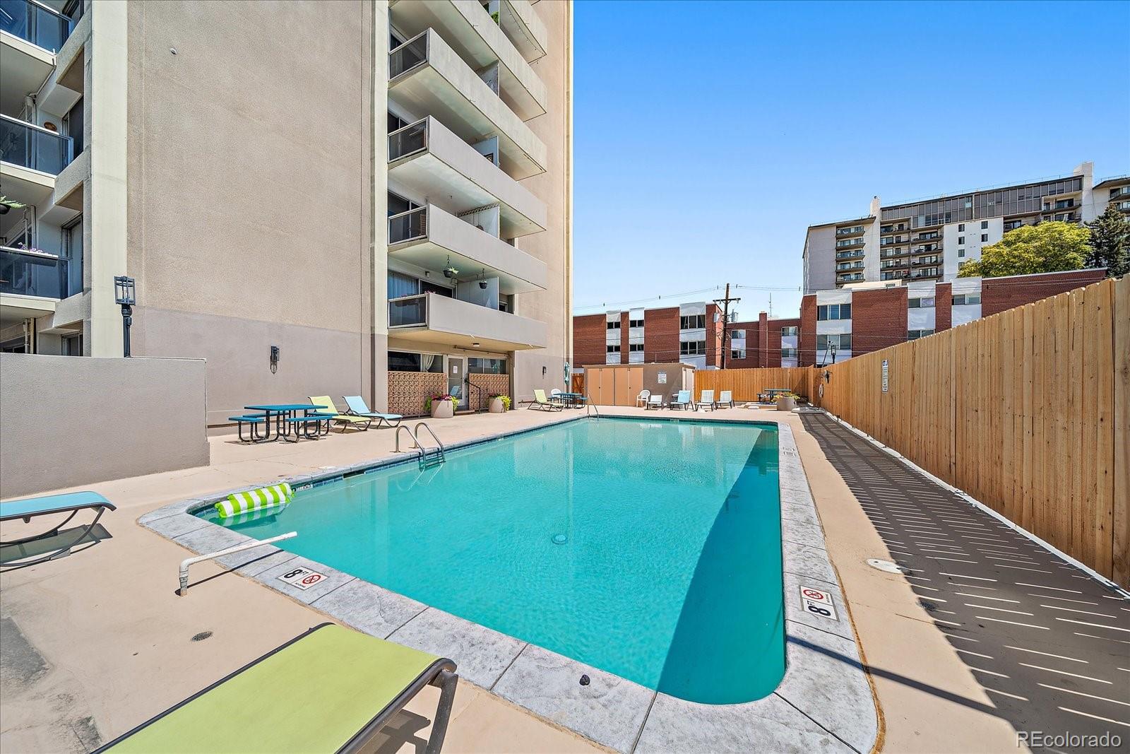 888 Logan Street, Unit 4F Denver, CO 80203 - Photo 16 of 21 a view of a swimming pool with a lounge chairs