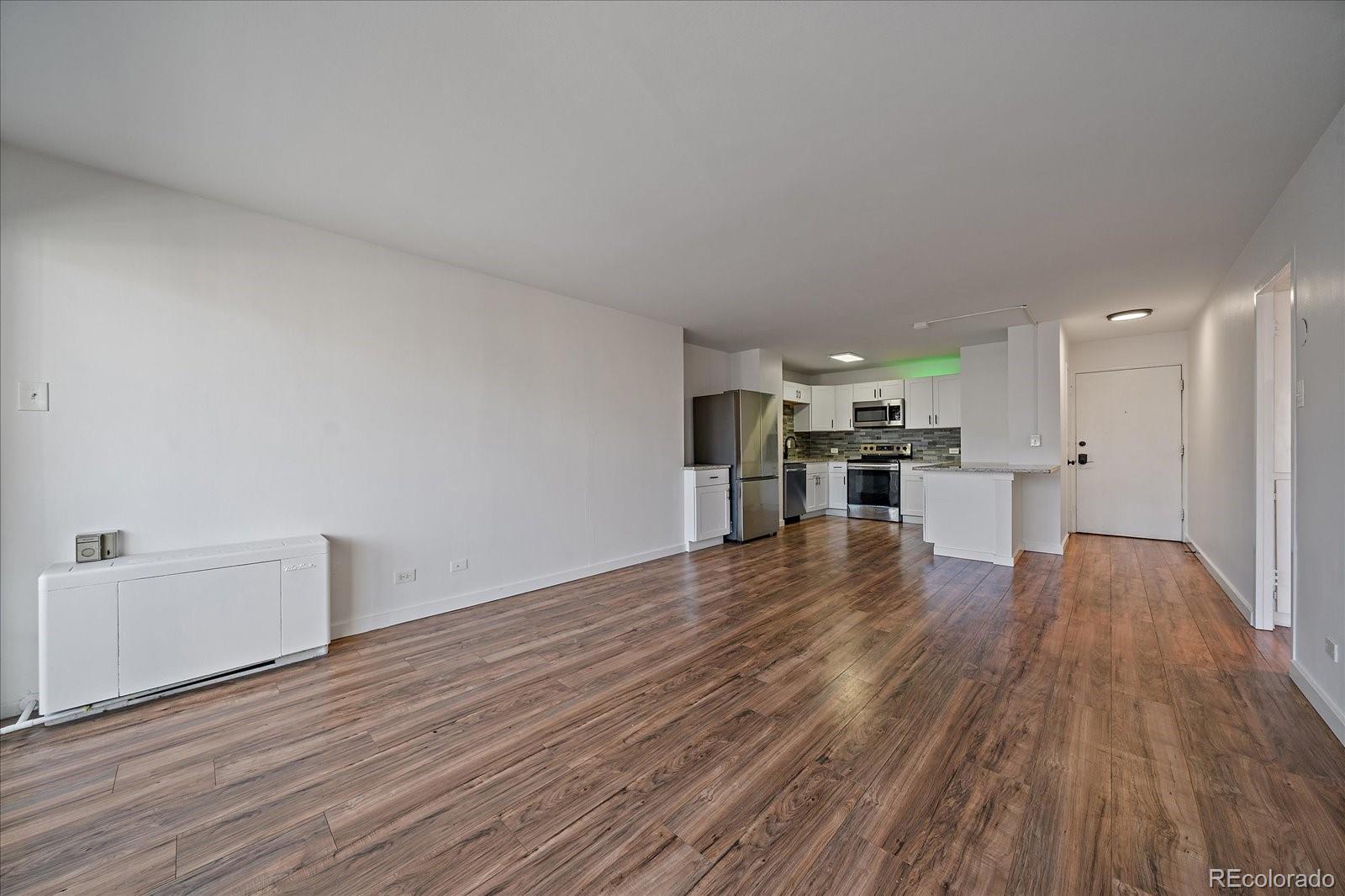 888 Logan Street, Unit 4F Denver, CO 80203 - Photo 6 of 21 a view of empty room with wooden floor