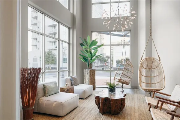 a living room with furniture and a potted plant