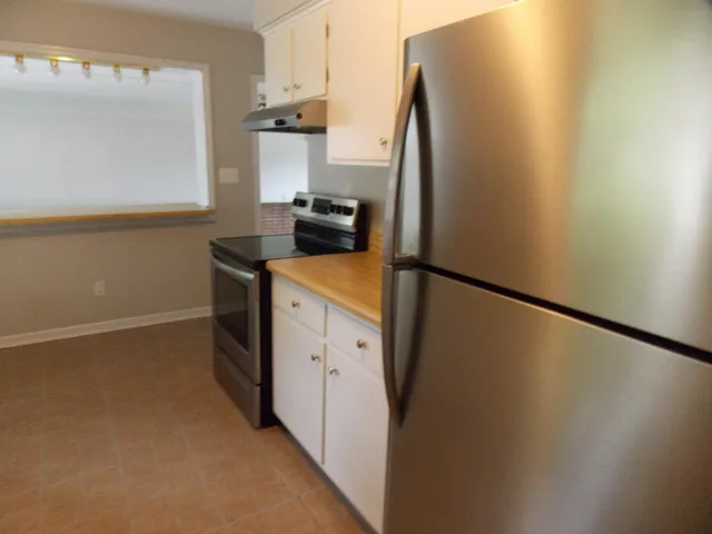 a kitchen with a refrigerator and a stove