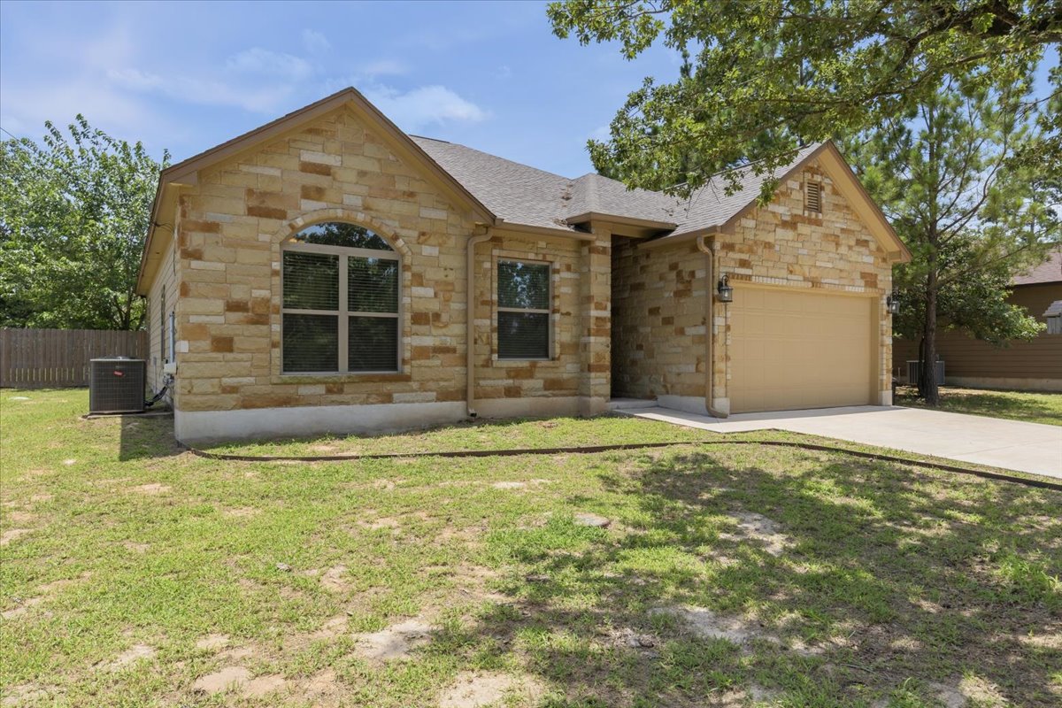 A classic stone facade with an arched window defines this inviting residence.