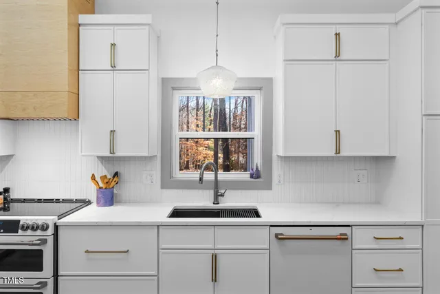a kitchen with a sink cabinets and window