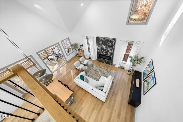a living room with furniture and floor to ceiling windows