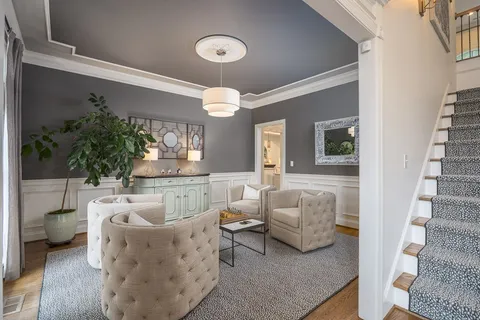 a living room with furniture and a floor to ceiling window