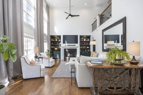 a kitchen with stainless steel appliances a stove a refrigerator and a fireplace