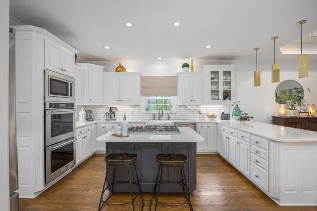 a kitchen that has a stove and a table