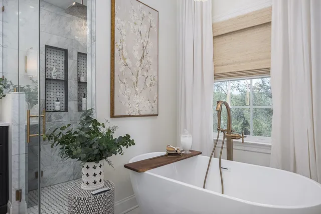 a en suite bathroom with a granite countertop tub sink and mirror