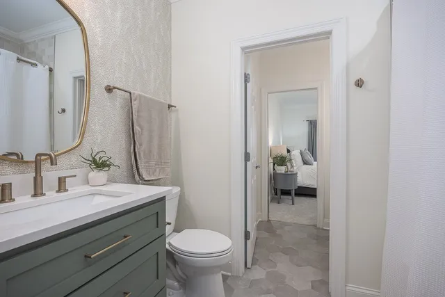 a bedroom with a bed and a potted plant
