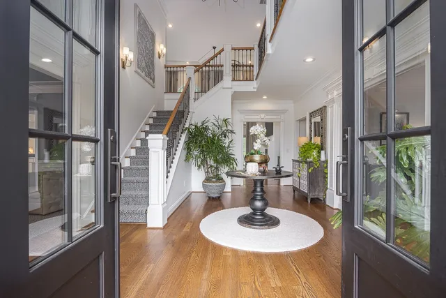 a living room with furniture a potted plant and a chandelier