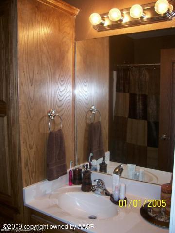 4512 Steffi Court Amarillo, TX 79110 - Photo 5 of 9 a bathroom with a sink and a mirror