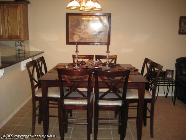 4512 Steffi Court Amarillo, TX 79110 - Photo 7 of 9 a view of a dining room with furniture and chandelier