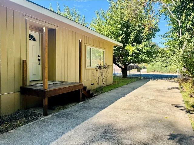 a backyard of a house with barbeque oven table and chairs