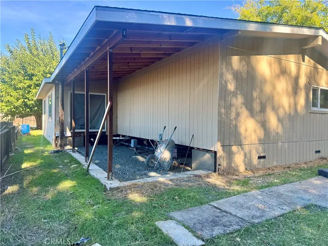 a view of a backyard with table and chairs a barbeque