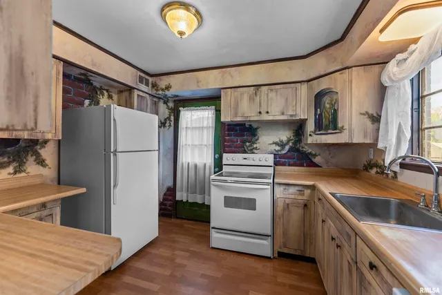 a kitchen with a refrigerator sink and stove