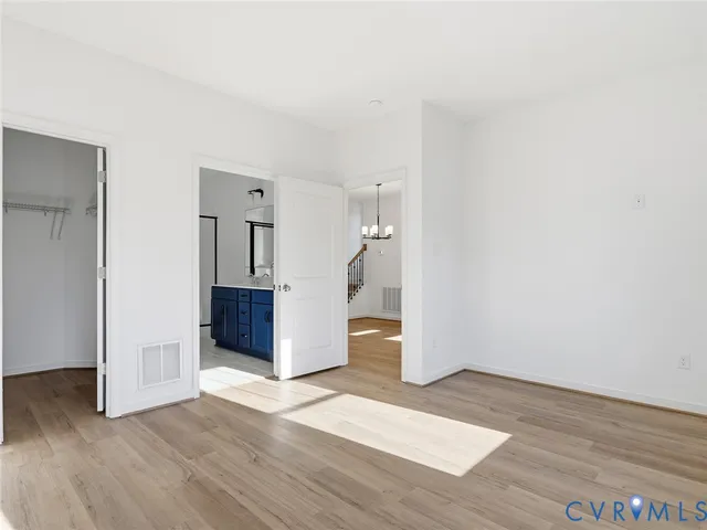 a view of a kitchen with wooden floor and stairs
