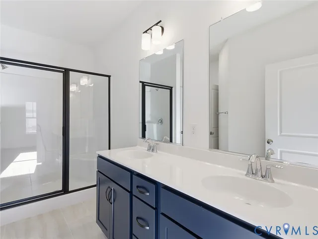 a bathroom with a double vanity sink and a mirror