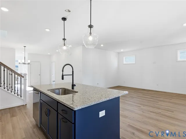 a kitchen with a sink and chandelier
