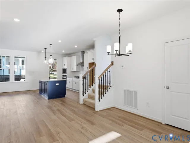 a view of a room with wooden floor and furniture