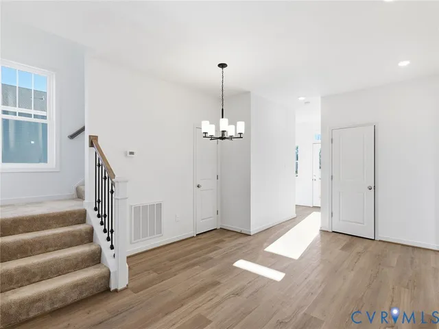 a view of a room with wooden floor and stairs