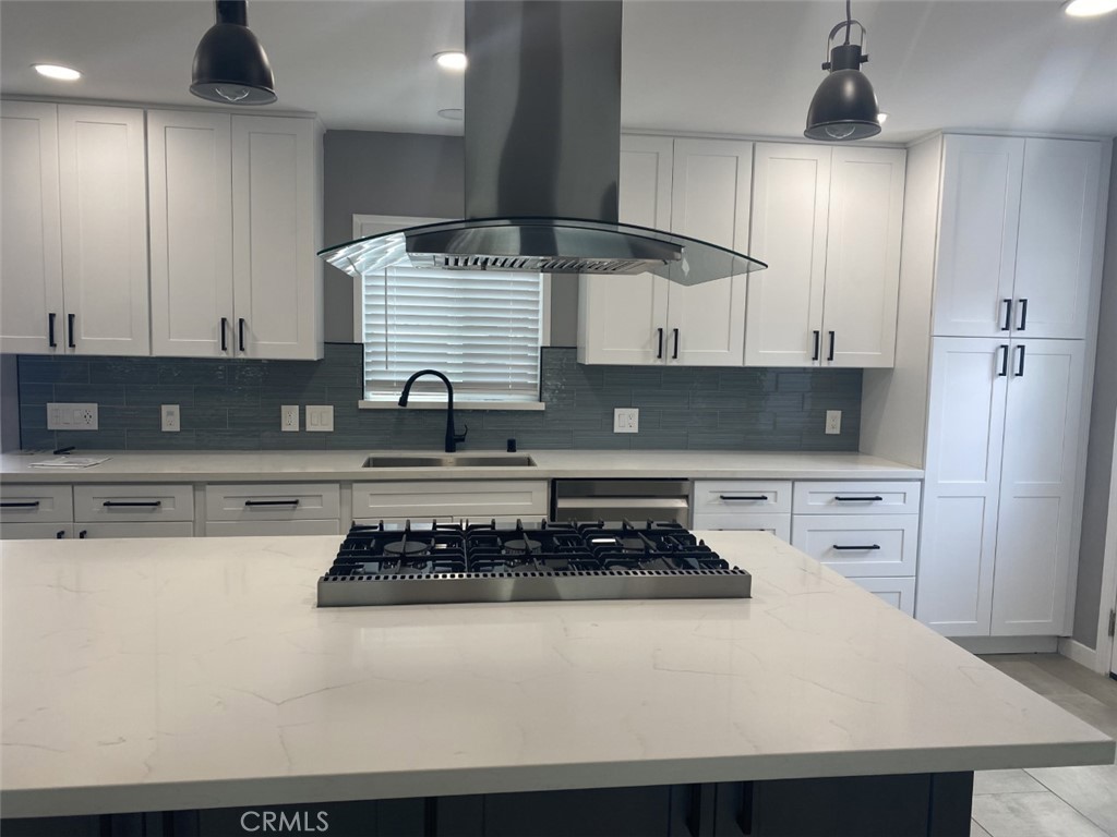 5591 Vallecito Avenue Westminster, CA 92683 - Photo 11 of 37 a kitchen with kitchen island granite countertop a sink a stove and refrigerator