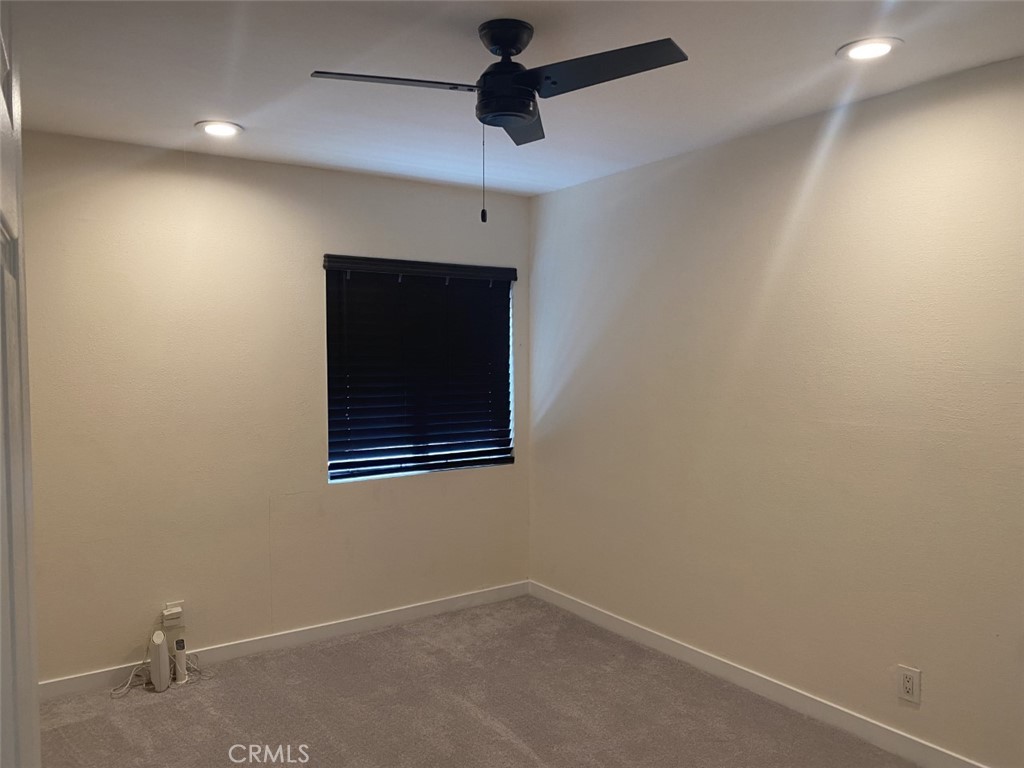 5591 Vallecito Avenue Westminster, CA 92683 - Photo 16 of 37 an empty room with a ceiling fan and carpet