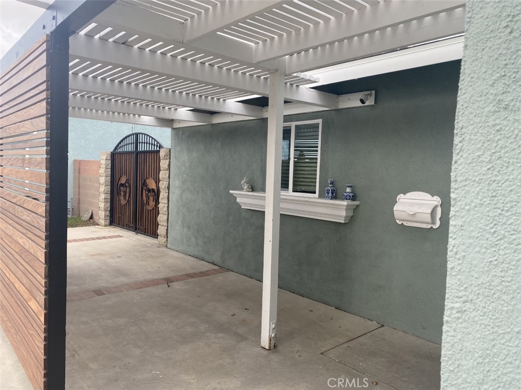 5591 Vallecito Avenue Westminster, CA 92683 - Photo 3 of 37 a view of a hallway with wooden cabinets and a floor to ceiling window