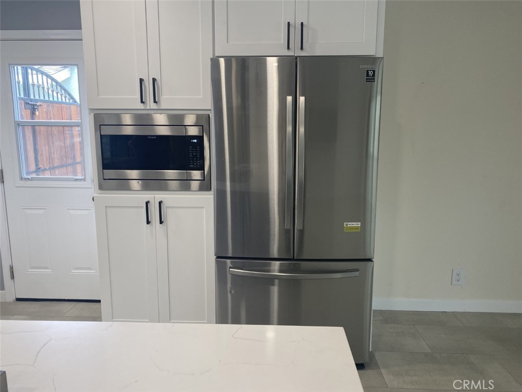 5591 Vallecito Avenue Westminster, CA 92683 - Photo 6 of 37 a metallic refrigerator freezer sitting in a kitchen