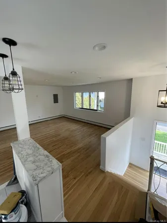 a living room with hard wood flooring and a couch