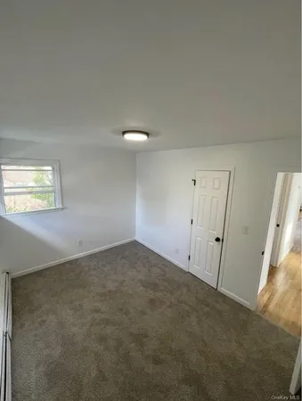 a view of an empty room and a window