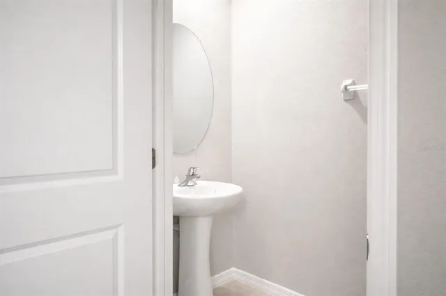 a bathroom with a sink a mirror and toilet