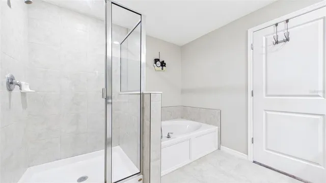 a bathroom with a bathtub and a shower